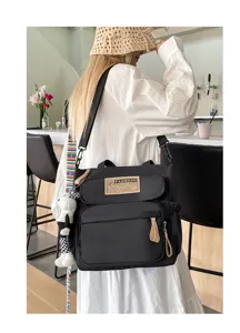 Bolso bandolera negro de lona para estudiantes, bolso informal con varios bolsillos.