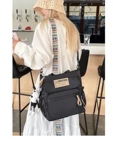 Bolso bandolera de lona casual para estudiantes con correa colorida y bonito colgante de cachorro.