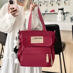 Bolso bandolera de lona duradero para estudiantes, bolso tote informal grande con bolsillos.
