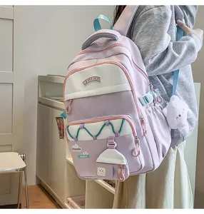 Gran mochila escolar para niñas, diseño en tonos pastel elegante con bonitos colgantes.
