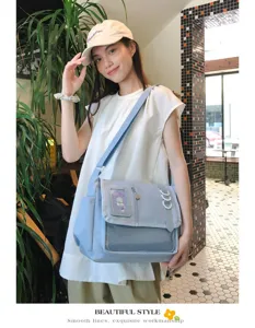 Detailed view of the cute blue messenger ita bag with transparent window and mesh front pocket.