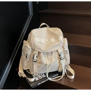 Lightweight nylon backpack with multiple pockets and drawstring closure for casual outdoor travel.
