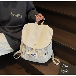 Detailed view of canvas backpack with drawstring closure, ideal for travel and commute.