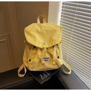 Detail view of the yellow casual backpack, featuring stylish minimalist design and durable straps.