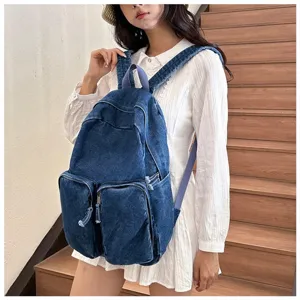 Detailed view of the retro Japanese style denim backpack with front pockets and durable straps.