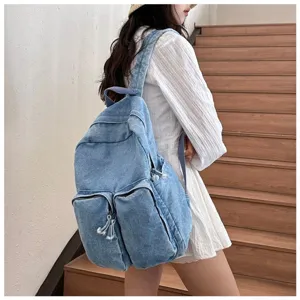 Casual denim backpack detail view, showcasing durable washed canvas fabric and functional pockets.