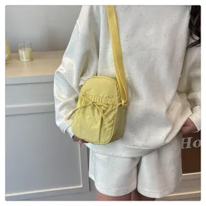 Simple waterproof nylon crossbody bag with bow detail, casual lightweight shoulder bag for women.