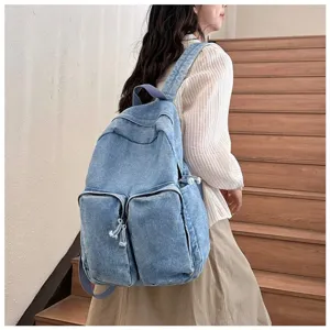 Casual denim backpack for daily use, featuring large capacity and stylish front pockets.