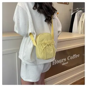 Casual waterproof nylon crossbody bag detail, featuring a cute bow drawstring design.