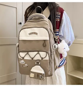 Mochila escolar bonita para niñas con múltiples bolsillos, gran capacidad y lindos dijes.