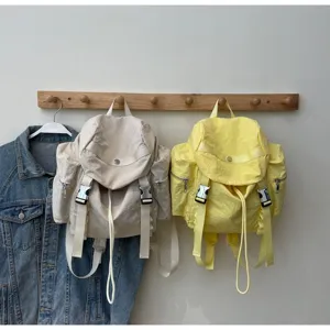 Detail shot of lightweight nylon backpack featuring multi-pocket design and secure buckles.