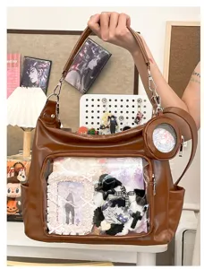 Detailed view of brown PU leather ita bag with clear window, perfect for anime pins display.