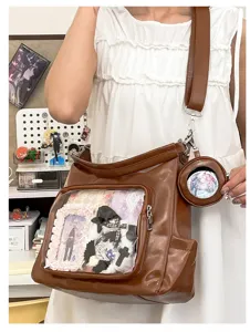 Close-up detail of the brown PU transparent ita bag showing the front clear display window.