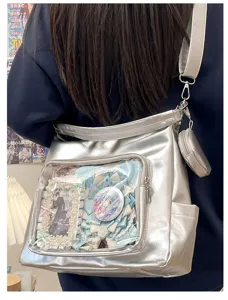 Clear ita bag detail showing silver tote design with transparent window for anime badges.