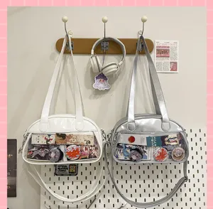 Detail view of clear transparent pocket ita shoulder bag with cute badges and inserts.