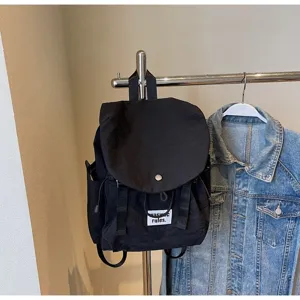 Minimalist black oxford cloth backpack for women, large capacity casual travel daypack.
