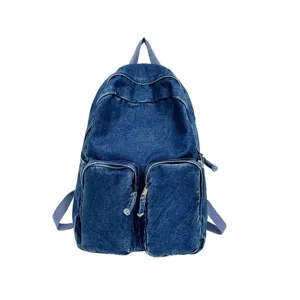 Denim backpack detail featuring durable washed fabric, dual front zip pockets and sturdy straps.