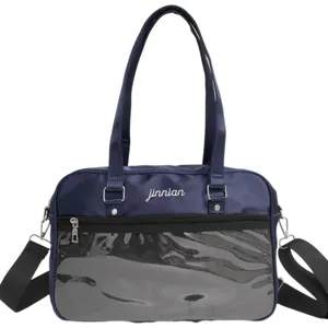 Detail view of dark blue ita bag with transparent front pocket, dual straps, and durable nylon.