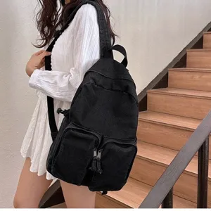 Simple black denim backpack for men and women, vintage casual school bag for daily use.
