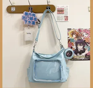 Clear ita bag detail view, light blue shoulder bag with front transparent display window.
