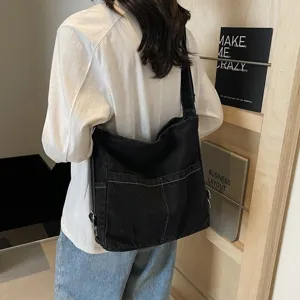 Sac à bandoulière en toile denim noir décontracté grand cabas fourre-tout femme quotidien.