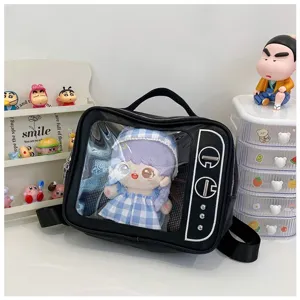 Detail view of black TV shaped transparent window ita bag displaying a cute plush doll inside.