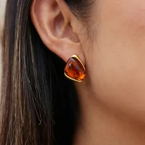 Detail view of vintage Maillard style amber resin gold stainless steel earrings worn nicely.