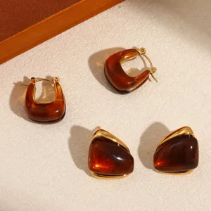 Detail view of retro Maillard style resin and stainless steel earrings, chic jewelry.