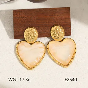 Luxury titanium steel heart earrings with 18k gold plating, stylish women jewelry detail view.