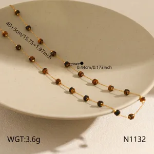 Elegant gold titanium steel beaded clavicle chain with natural brown stone accents for women.