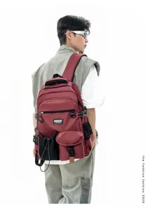 Detailed view of the red casual backpack worn by a model, featuring multi-pockets design.