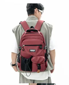 Detail view showcasing the premium burgundy canvas backpack worn comfortably by a model.