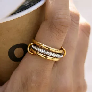 Detailed close-up of a stylish multi-layered stacked ring featuring sparkling crystals.