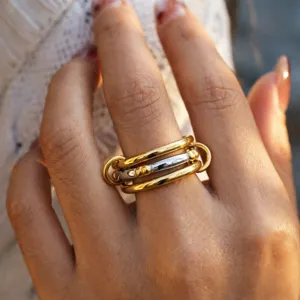 Stainless steel multi-layer stacked ring detail shot, showcasing unique two-tone metallic design.