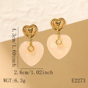 Detail view of French style double heart dangle earrings in gold tone with pink resin and crystal.