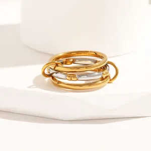 Detail shot of multi-layer interlocking stainless steel ring, gold and silver finish ring.