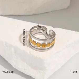 Stainless steel open ring featuring a double band and gold floral cutout design.
