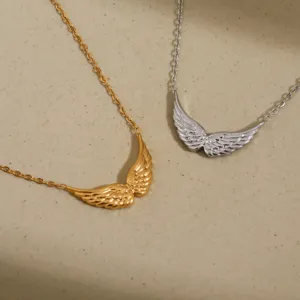 Detailed close-up of dual-tone angel wing necklaces in gold and silver, elegant metal jewelry.