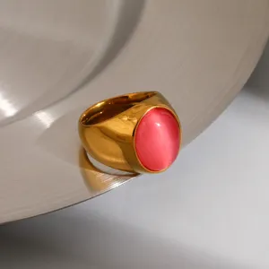 Gold stainless steel ring detail shot showcasing the vibrant pink oval gemstone accent.