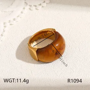 Detailed view of wide stainless steel ring with brown resin inlay, modern geometric chic style.
