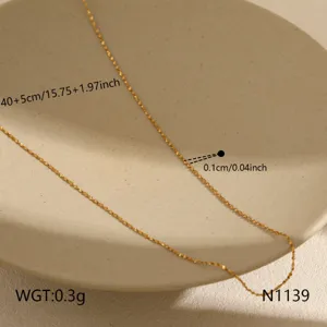 Detailed view of the thin gold minimalist clavicle chain necklace with size and weight specs.