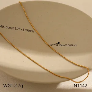 Dainty gold bead chain necklace with adjustable length, elegant stainless steel jewelry detail.