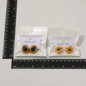 Detailed view of retro geometric stainless steel earrings with black stone and woven knot designs.