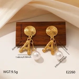 Detailed view of vintage gold letter A pearl earrings with dimension markers, elegant display.