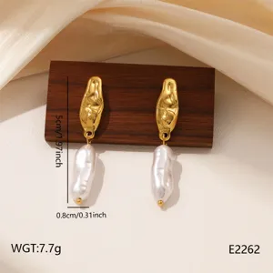 Detailed view of irregular metal and baroque pearl drop earrings, retro chic design.
