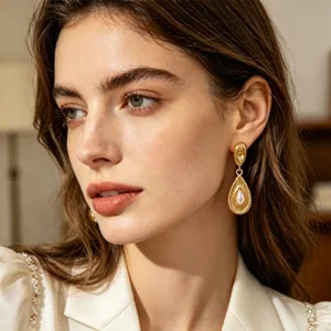Vintage gold-toned teardrop pearl earrings for women, elegant retro drop dangle jewelry design.