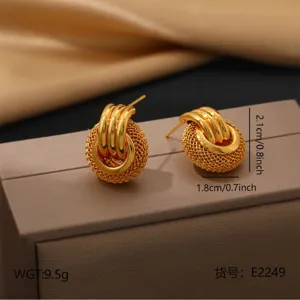 Vintage woven stainless steel stud earrings detail, elegant 18k gold plated geometric jewelry.