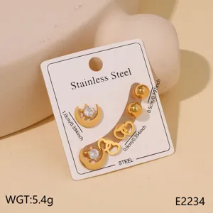 Stainless steel gold earring set featuring moon star heart and ball designs with cubic zirconia.