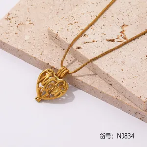 Primer plano de un collar con colgante de corazón de acero inoxidable dorado con detalles.