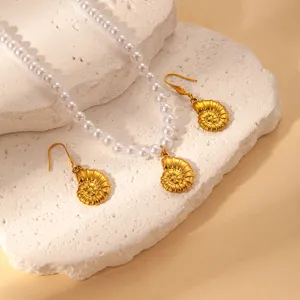Exquisite golden conch pendant necklace and earrings set featuring elegant white pearls, fine detail.